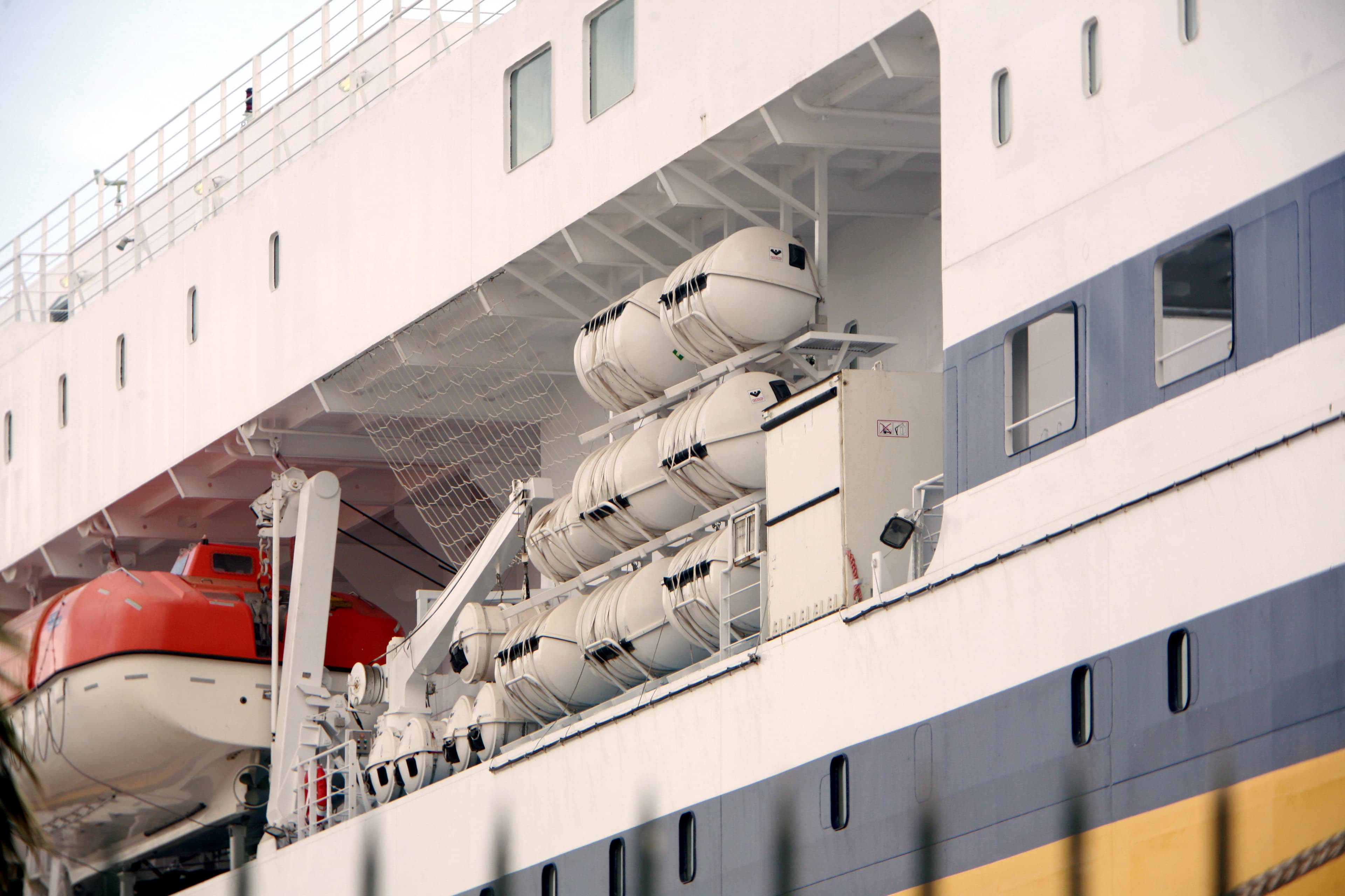 Multiple VIKING liferaft containers secured in racks on a ship