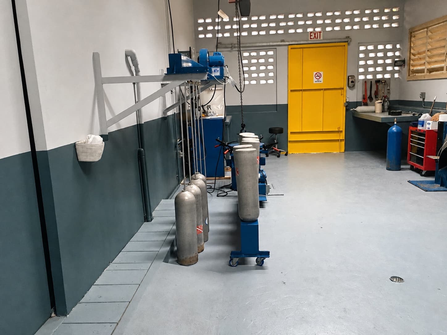 Marine cylinders arranged beside hydrotesting equipment in The Safety Pelican workshop