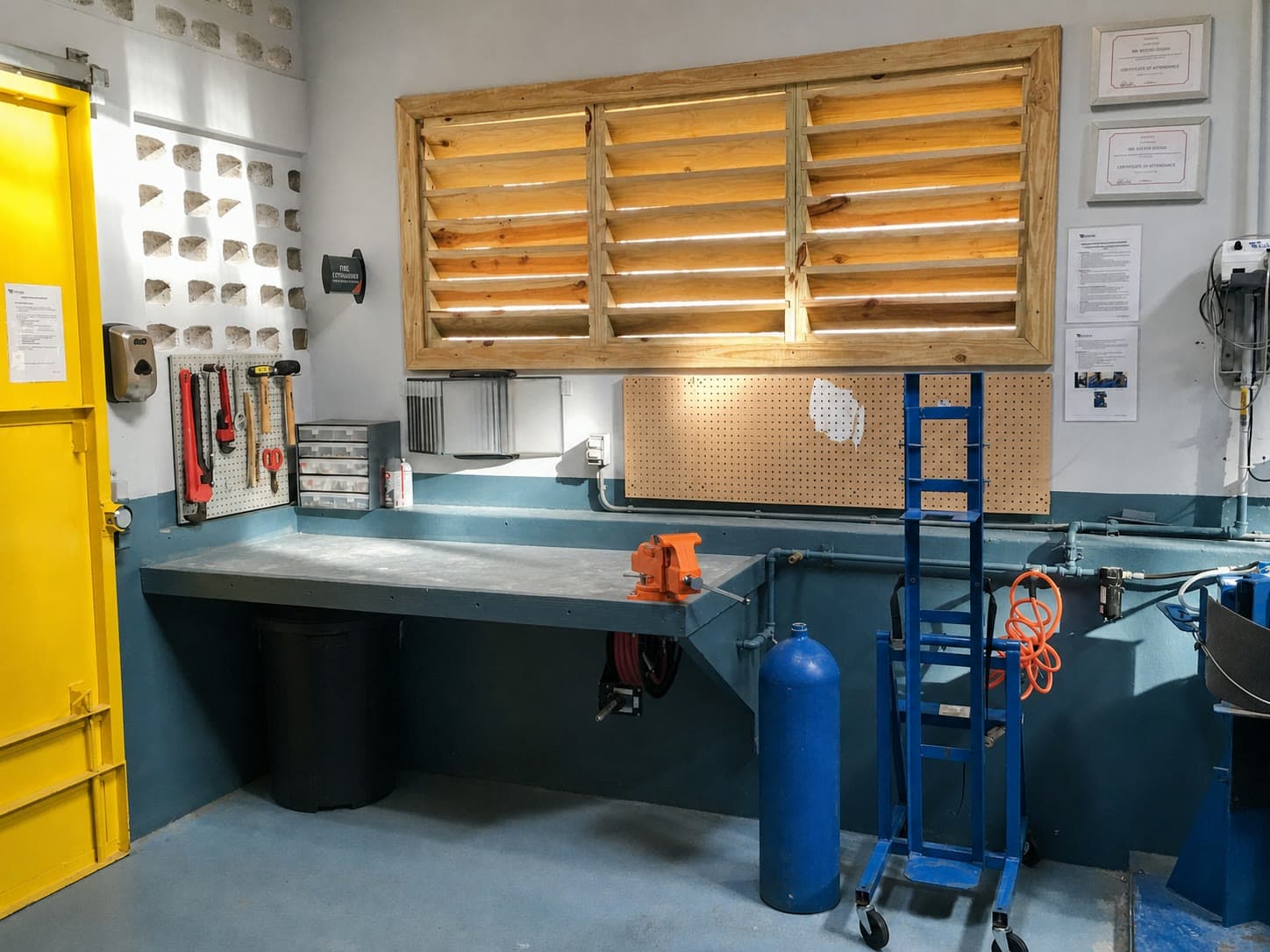 Organized workshop bench, cylinder handling equipment and service records